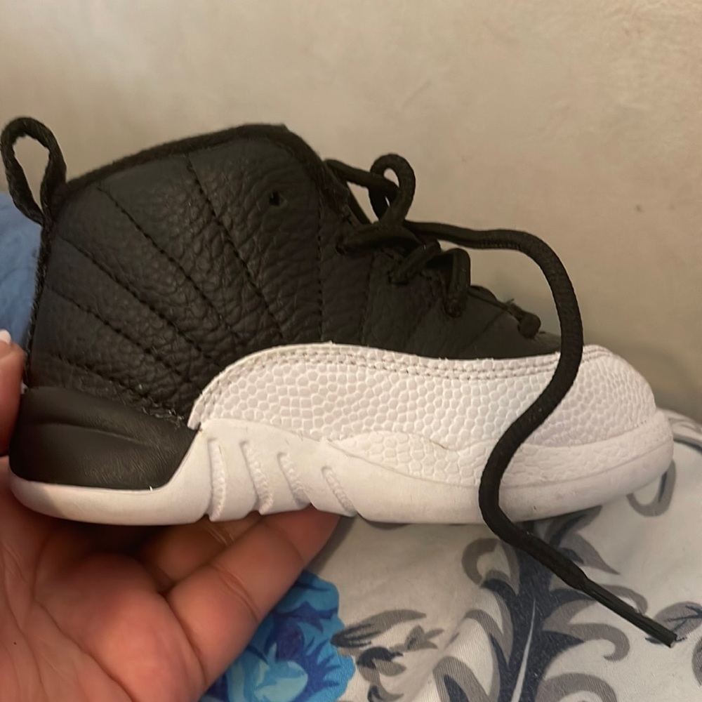 Jordan 12’s black and white with red Jordan sign